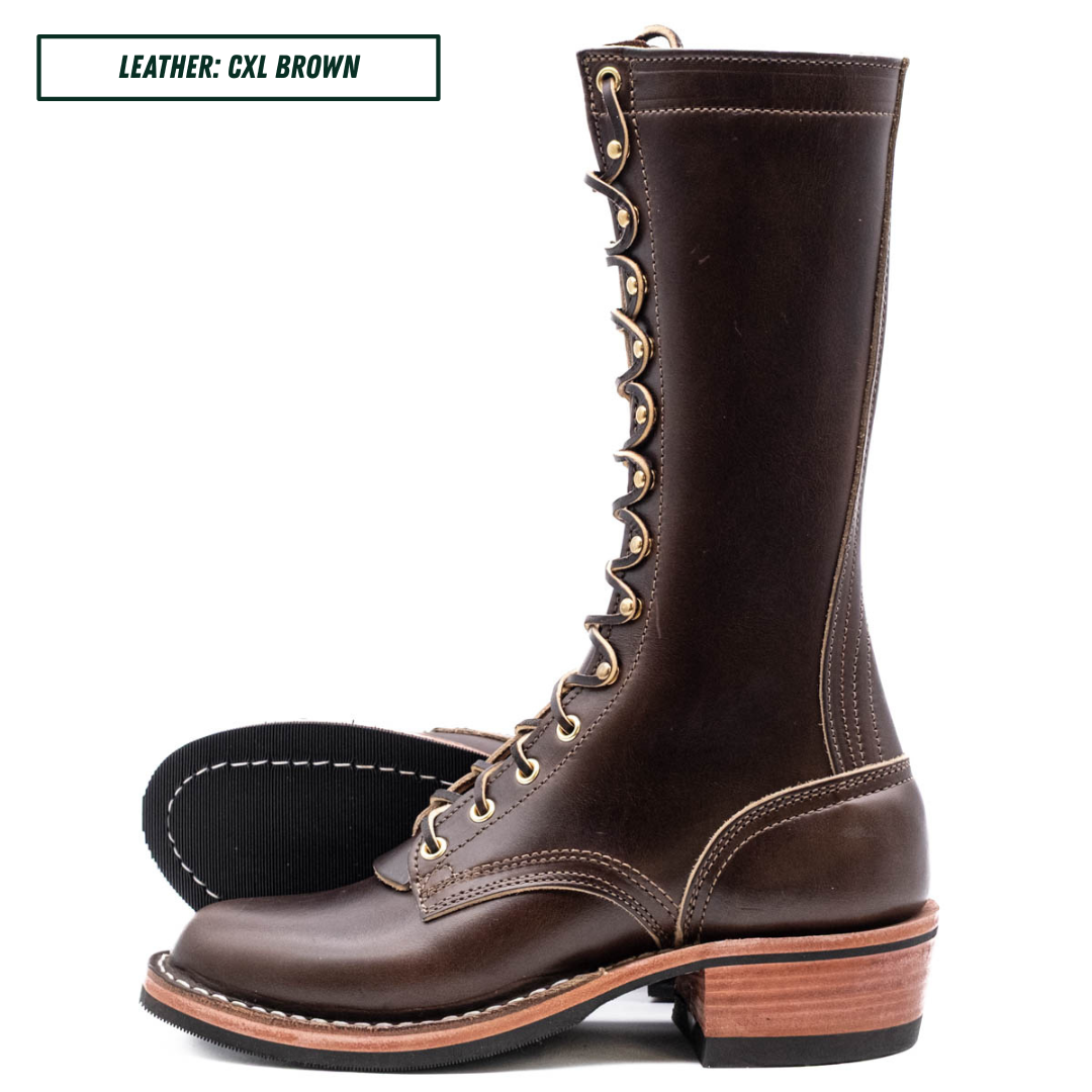 A dark brown leather lace-up boot with a stacked wood-look heel, shown on a white background with a second boot turned around to display the black outsole. A text label in the top left reads 'LEATHER: CXL BROWN'.