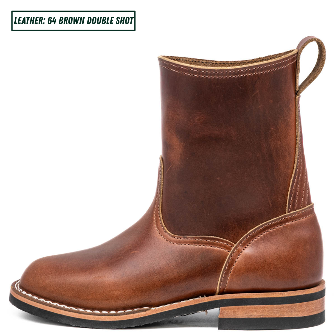 A single brown leather ankle boot shown in side profile on a white background, with a small text label in the top-left corner reading 'LEATHER: 64 BROWN DOUBLE SHOT'. The boot has a rounded toe, elastic side gore, pull loop, and stacked sole.