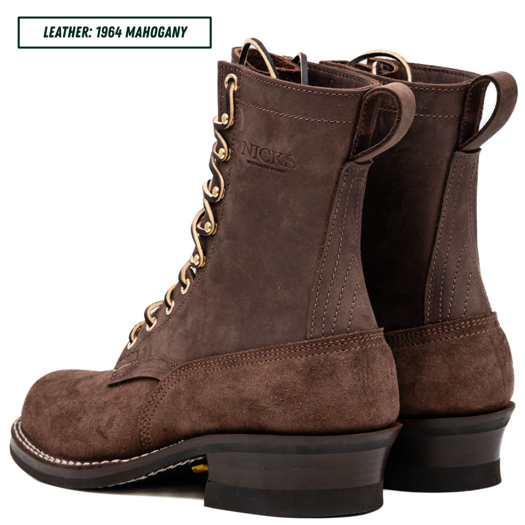 A pair of dark brown suede lace-up boots shown from a three-quarter angle on a white background, with a text label in the top-left corner reading 'LEATHER: 1964 MAHOGANY'.