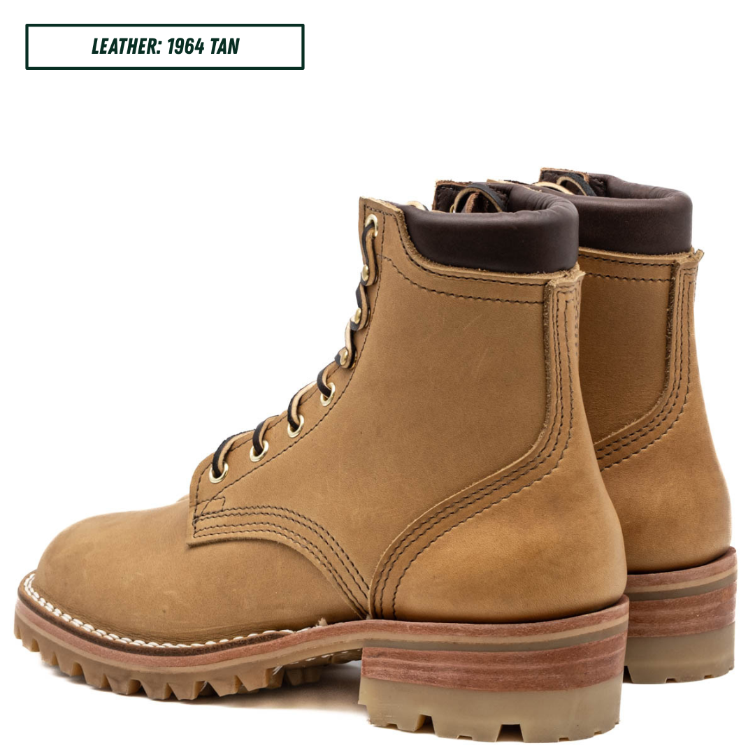A pair of tan leather lace-up ankle boots shown on a white background, with a text label in the top left reading 'LEATHER: 1964 TAN'. The boots feature a rugged lug sole, stacked midsoles, and dark brown collar lining.
