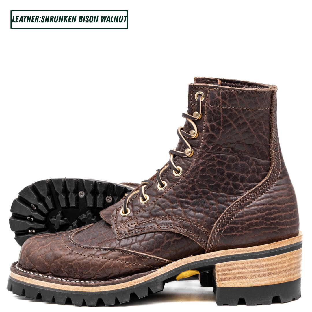 A pair of dark brown leather lace-up boots with a textured, shrunken finish, gold-tone eyelets, and chunky stacked soles, shown on a white background with a text label in the top left corner.