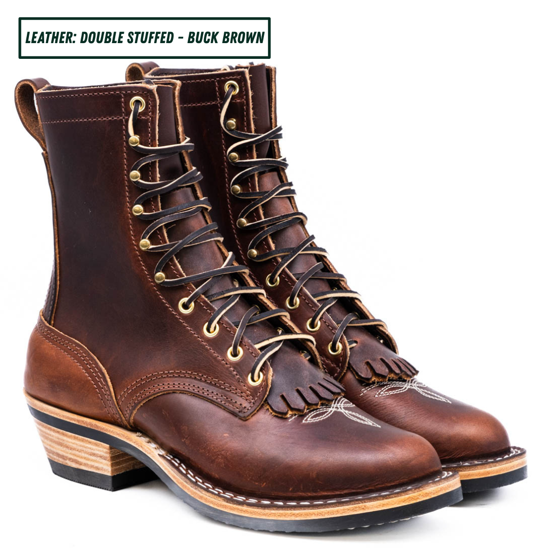 A pair of double-stuffed buck brown leather lace-up boots with kilties, stacked on a white background with a text label at the top left.