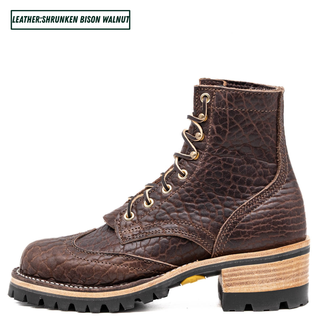 A dark brown textured leather lace-up boot with a chunky stacked block heel, black lug sole, and light tan midsole layer. The text 'LEATHER:SHRUNKEN BISON WALNUT' is displayed in the top-left corner.