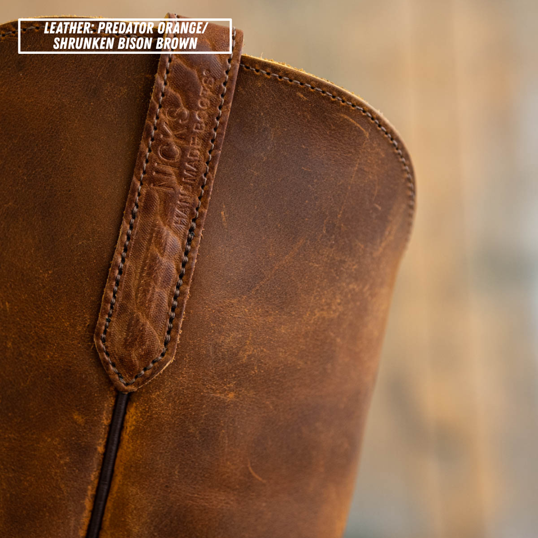 Detail shot of side pull loop on Palouse western boot. Top left reads 'LEATHER: PREDATOR ORANGE/ SHRUNKEN BISON BROWN'.