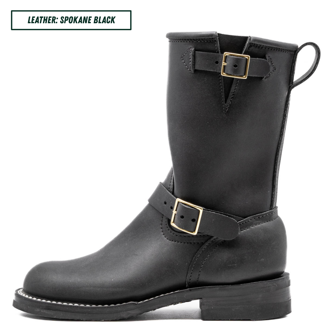 A black leather mid-calf boot with gold-tone buckle details, shown in a side profile on a white background. A text label in the top-left corner reads 'LEATHER: SPOKANE BLACK'.