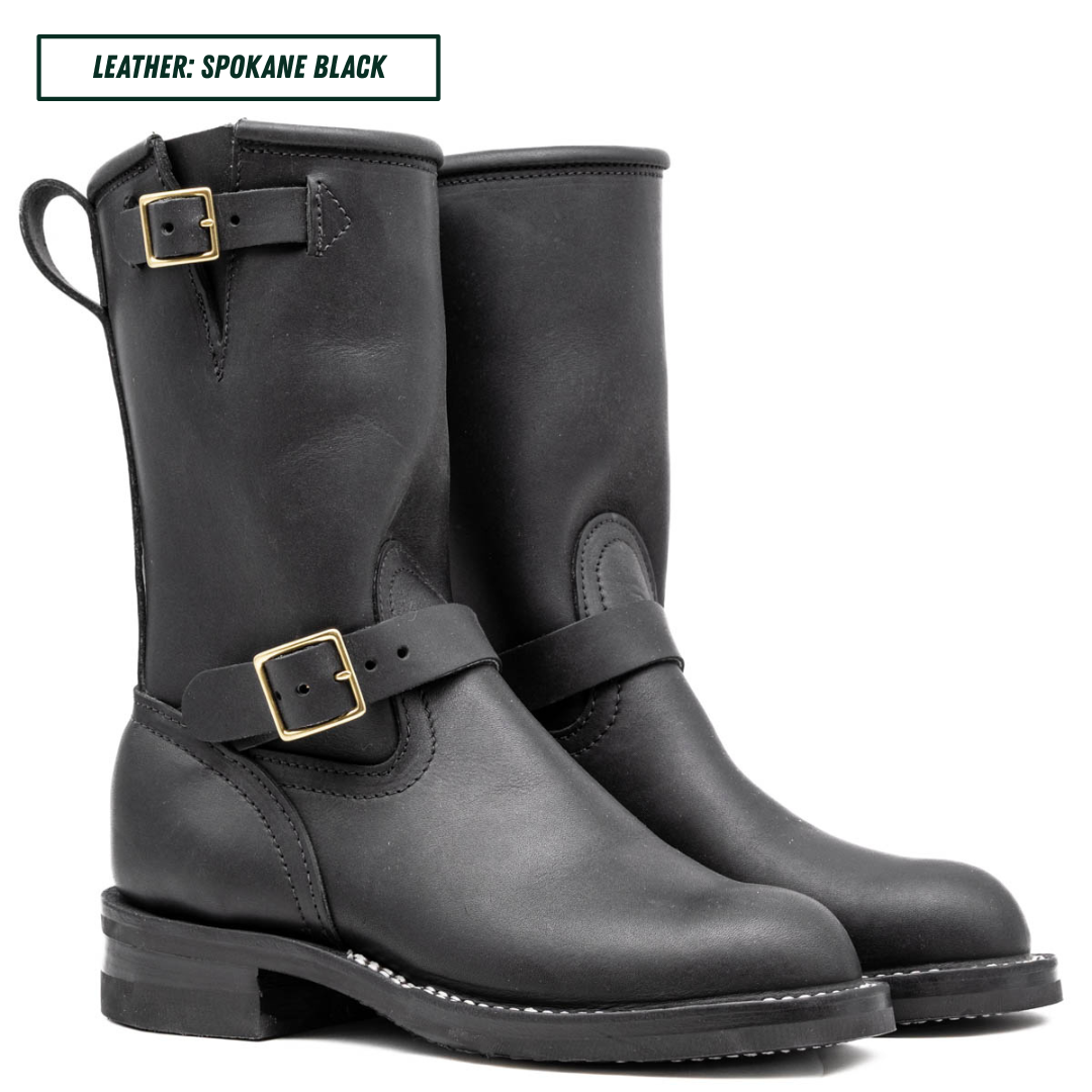 A pair of black leather mid-calf boots with gold-tone buckle straps, shown on a white background with a text label at the top reading 'LEATHER: SPOKANE BLACK'.