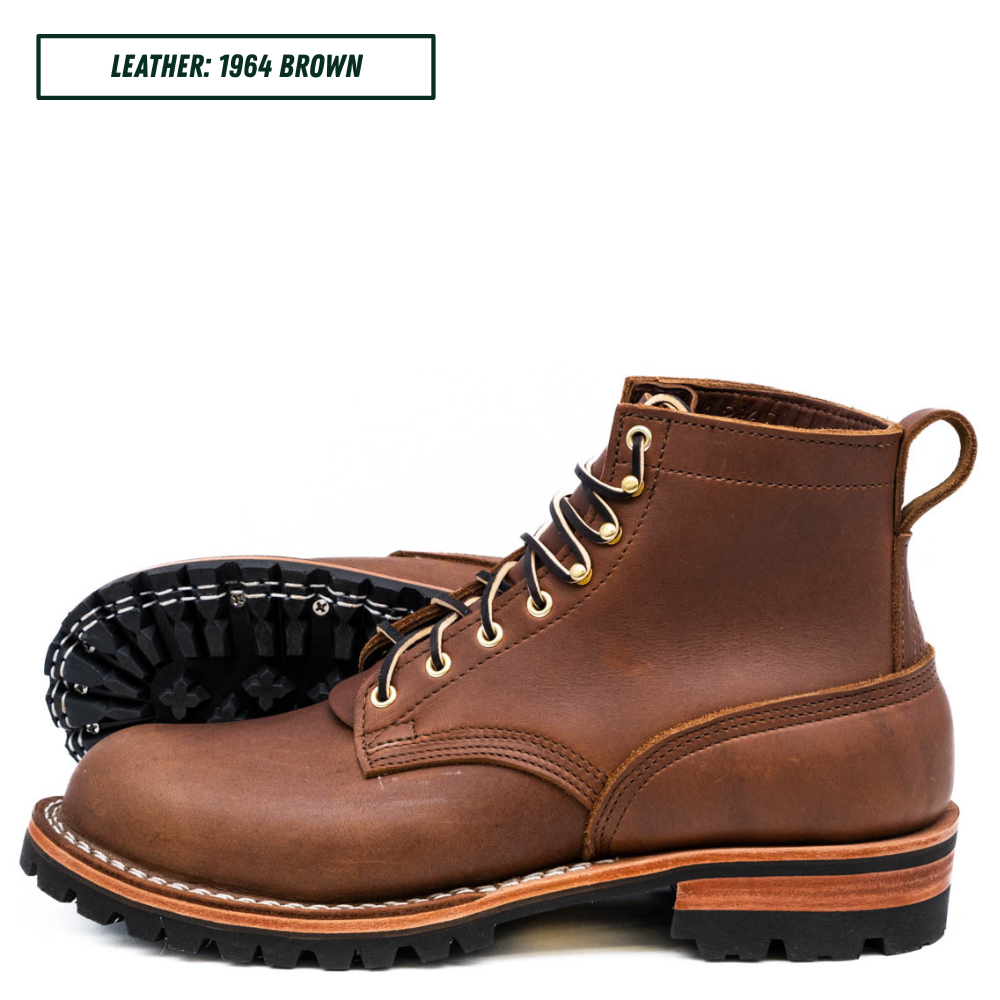 A pair of brown leather lace-up work boots shown on a white background, with one boot standing upright and the other lying on its side to display the black treaded sole. A text label in the top left reads 'LEATHER: 1964 BROWN'.