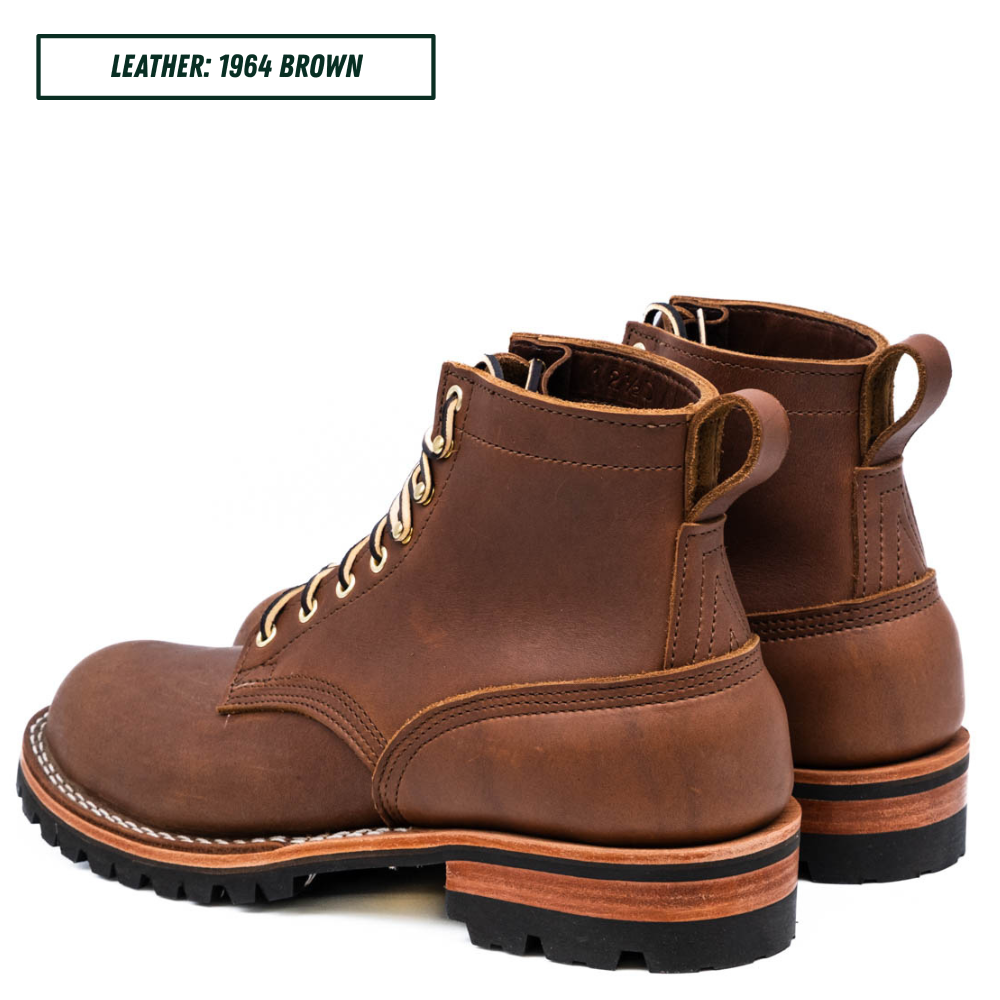 A pair of brown leather lace-up ankle boots shown on a white background, with a text label in the top-left corner reading 'LEATHER: 1964 BROWN'. The boots feature tan laces, pull tabs, and a rugged black sole with a layered tan and black heel.