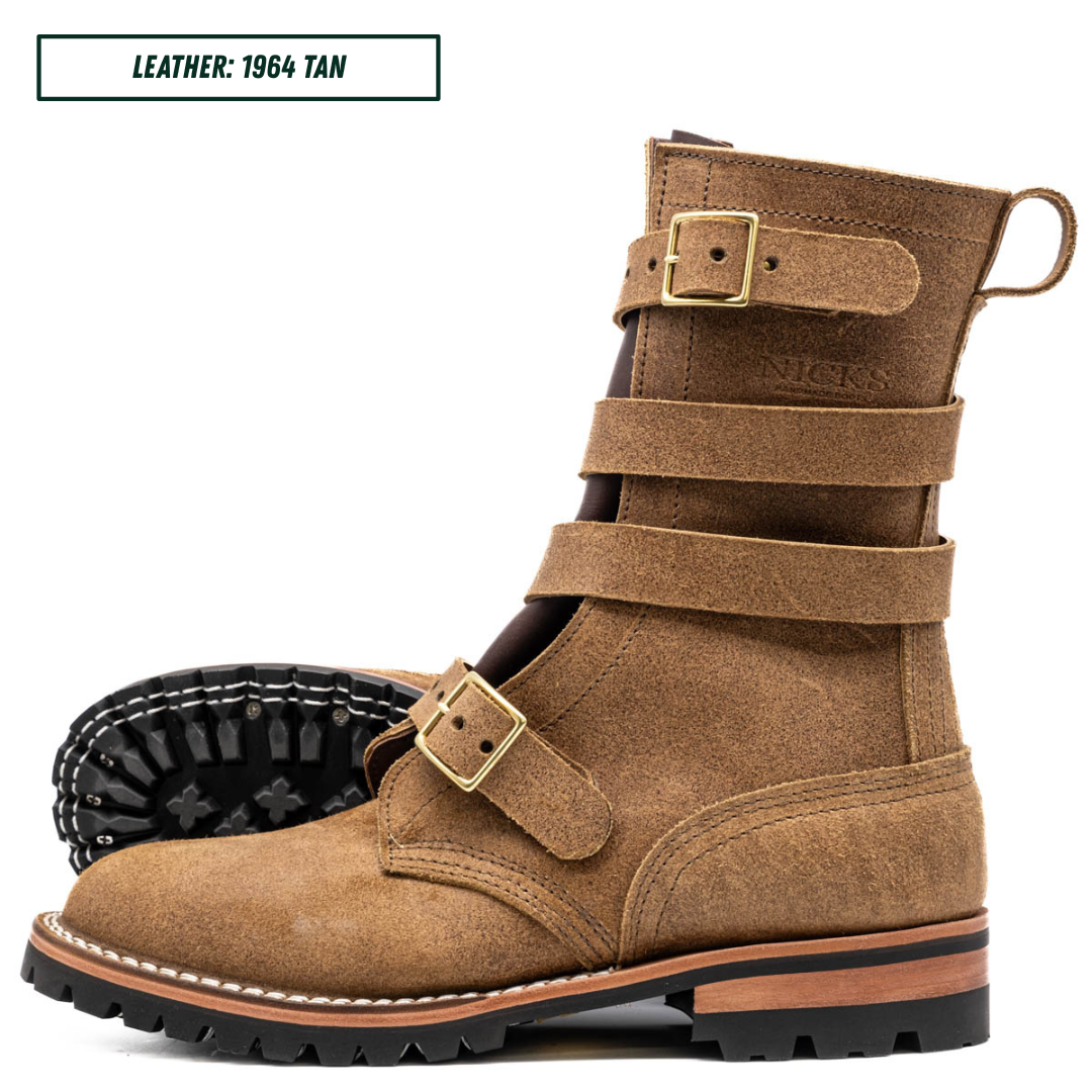 A tan suede mid-calf boot with multiple strap details and gold-tone buckles, shown on a white background with a second boot showing the sole behind it. A text label in the top left reads 'LEATHER: 1964 TAN'.