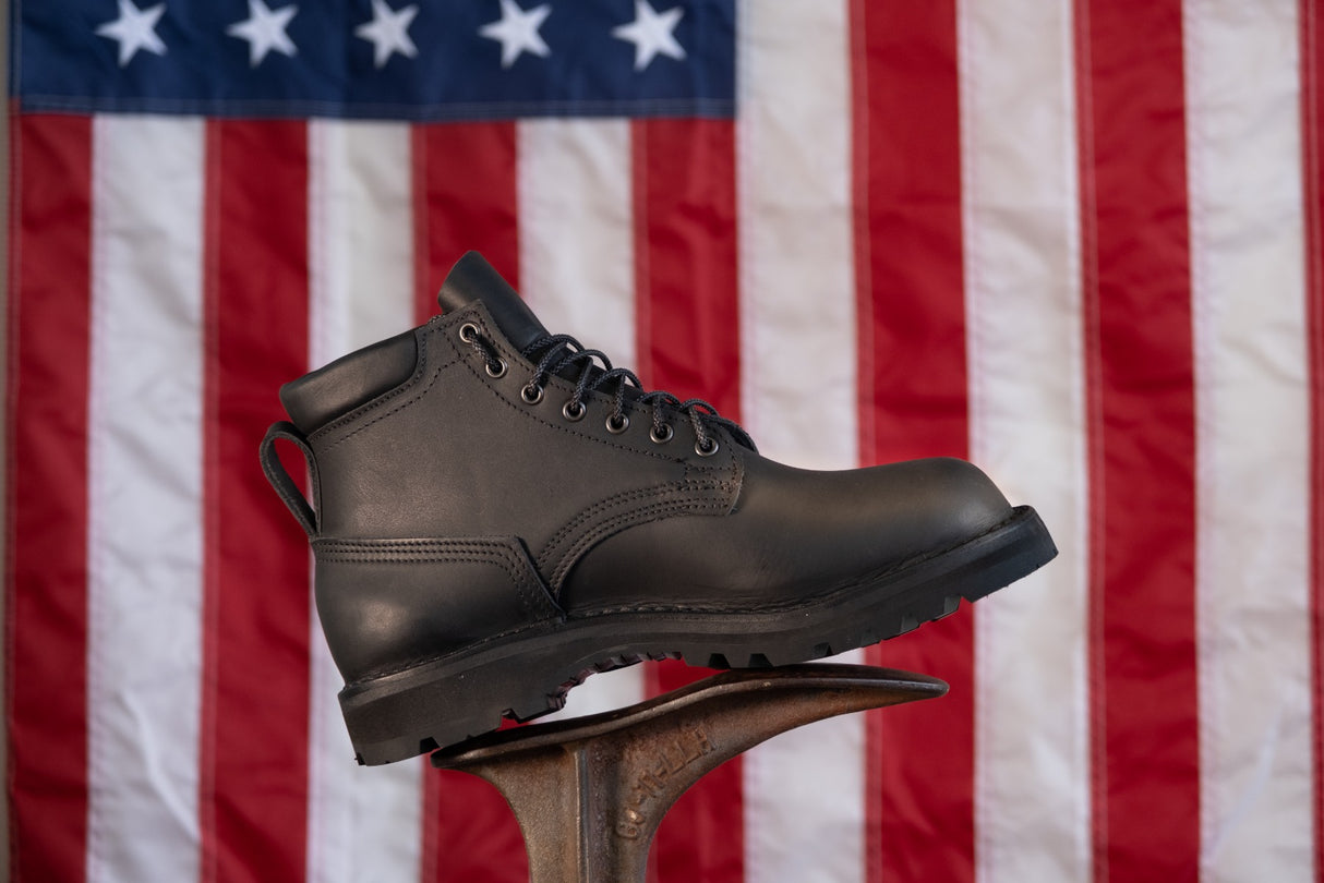 5 inch black boot with padded color.  Vibram Sierra aggressive sole.  Pull loop on back.  American flag in the background.