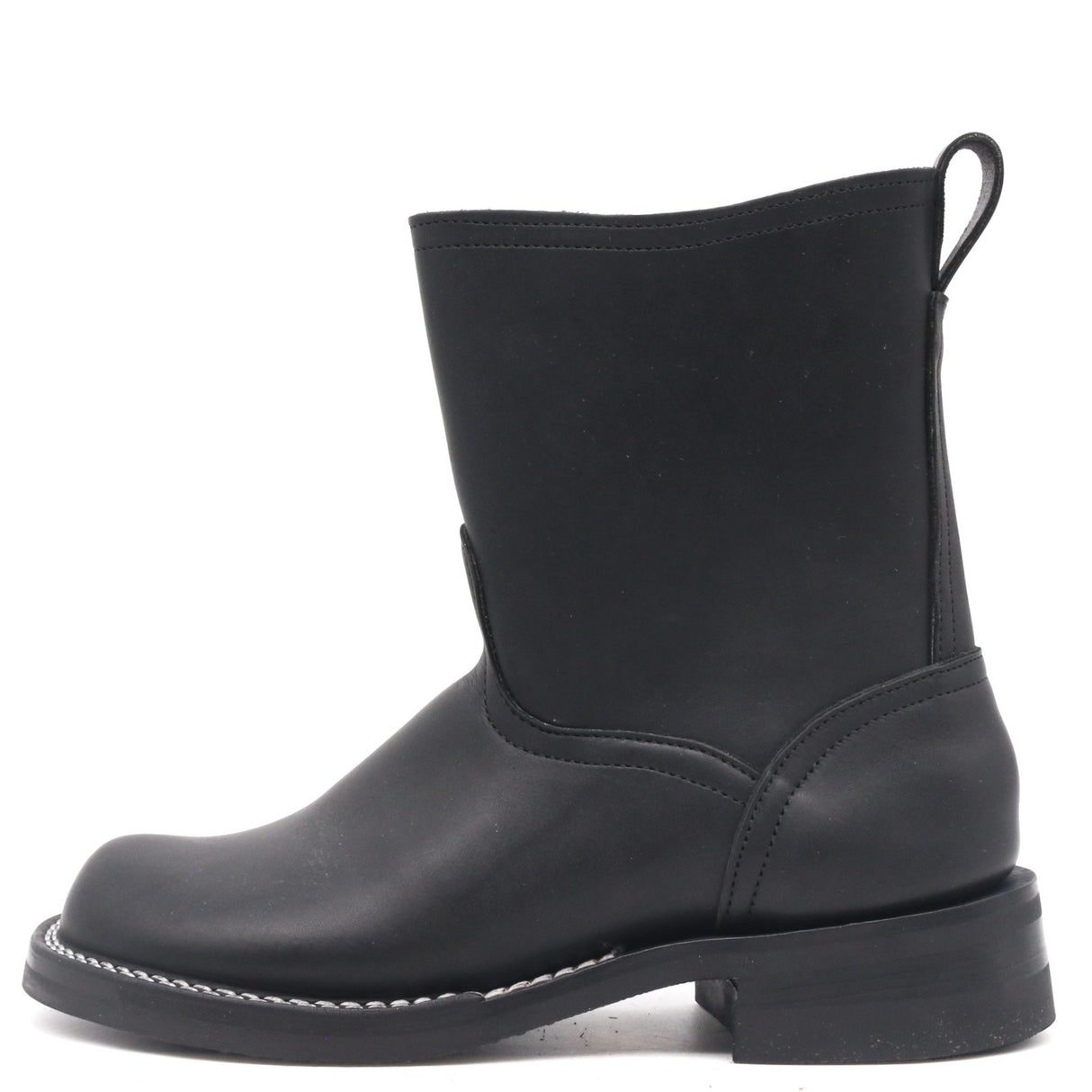 Black pull on boot on a white background. Black edge dressing white sole stitching
