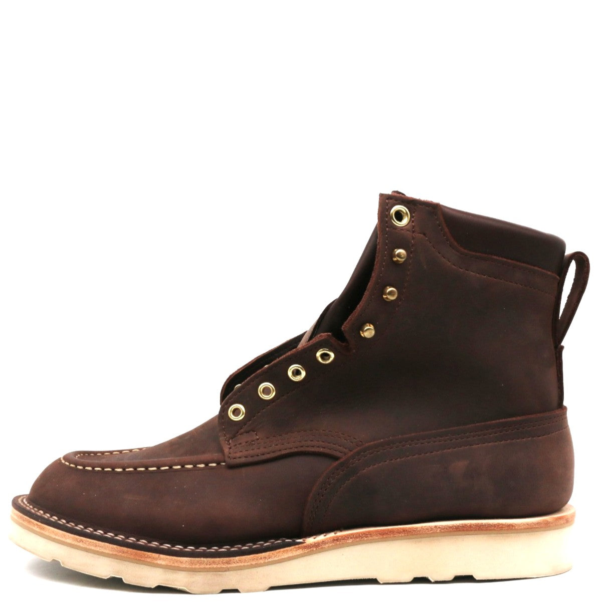 A dark brown suede lace-up boot with brass eyelets and a light tan sole, shown from a side profile on a white background.