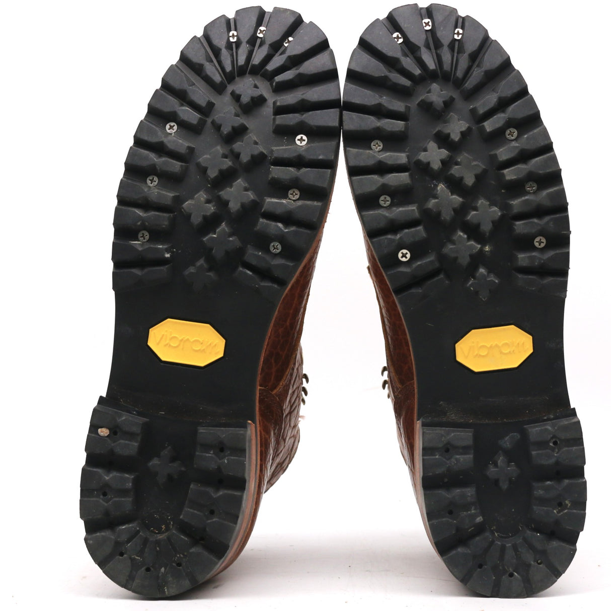 Close-up of black rubber sole with tread pattern on a white background