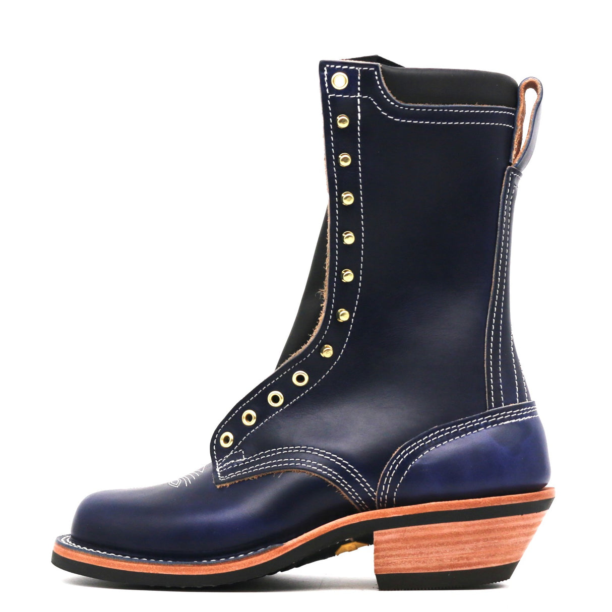 A dark navy blue leather lace-up boot with gold-tone metal eyelets, white contrast stitching, and a stacked wood-look heel, shown from a side profile on a white background.