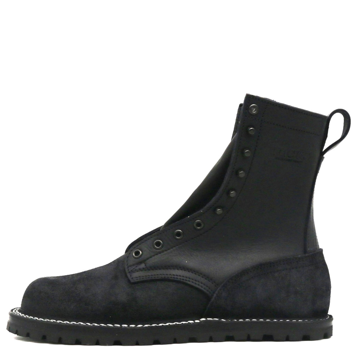 A black leather and suede lace-up ankle boot with metal eyelets, white contrast stitching along the sole, and a pull tab at the heel, shown from a side profile on a white background.