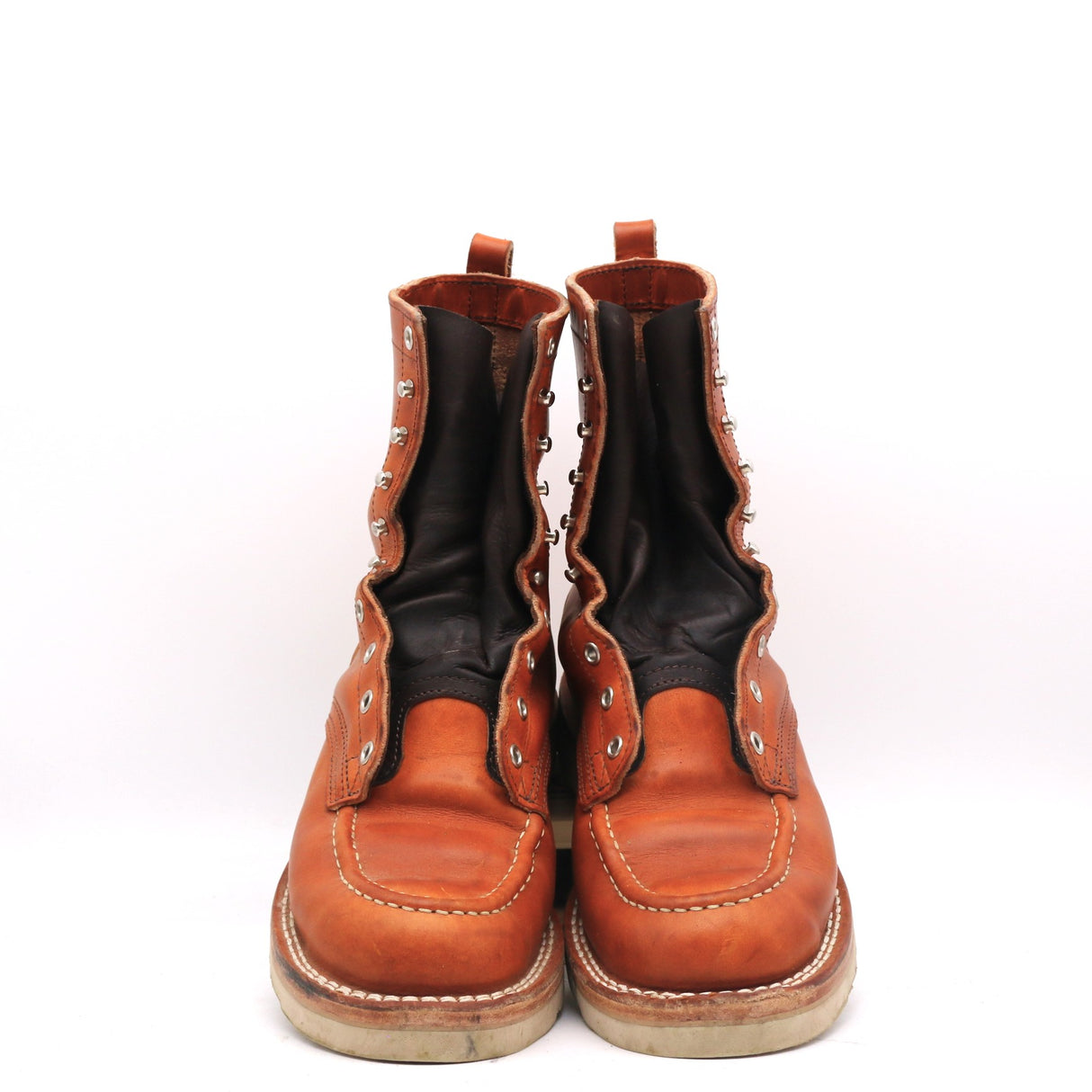 A pair of brown leather lace-up ankle boots with black elastic side panels and silver metal eyelets, photographed against a plain white background.