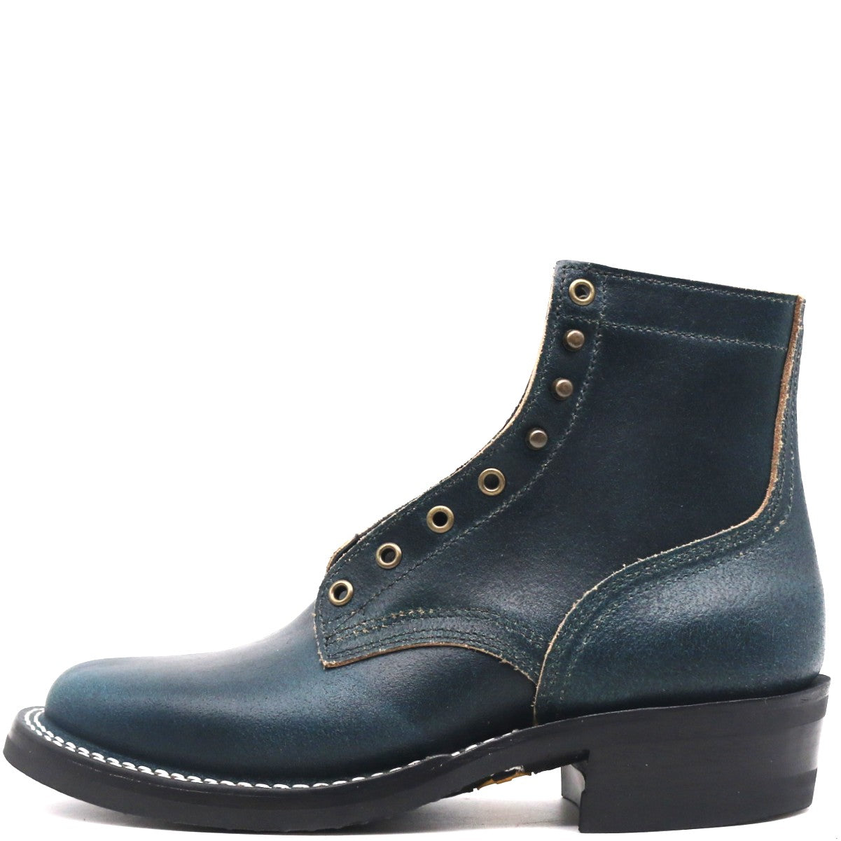 A dark teal leather ankle boot with decorative brass eyelets, contrast stitching, and a black stacked heel, shown from a side profile on a white background.