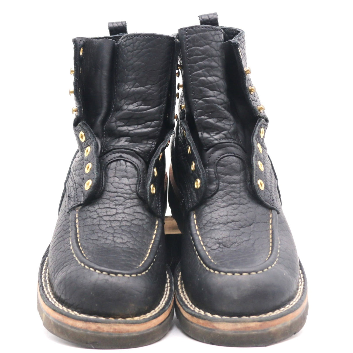 A pair of black leather ankle boots with gold-tone metal eyelets and studs, featuring contrast stitching and a tan welt, photographed against a plain white background.