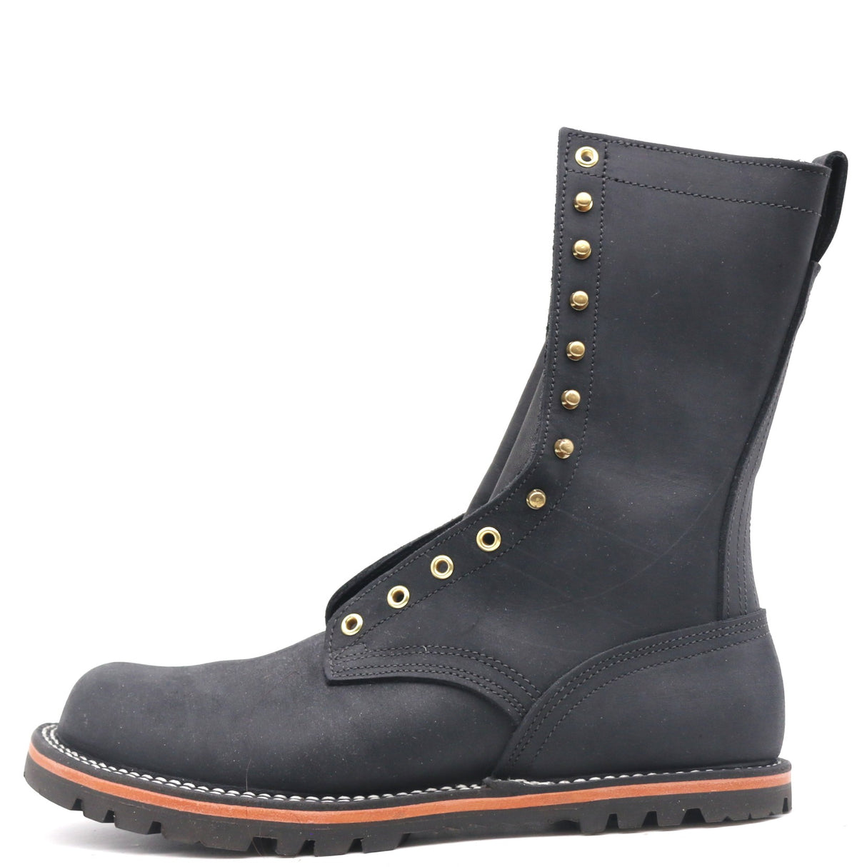 Tall black boot built on a zero-drop flat last with brass hardware in front of a while background.
