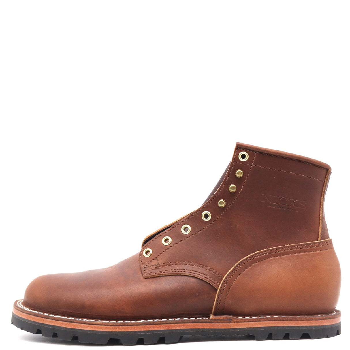 Brown zero drop ankle boot with brass hardware in front of a white background.