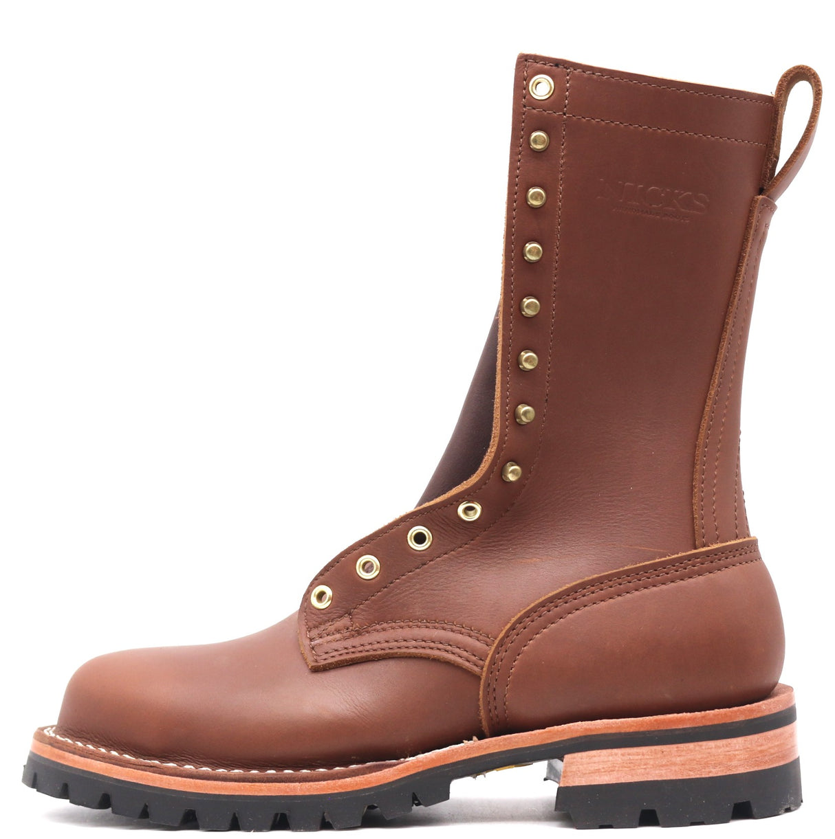 A brown leather work boot with brass eyelets and studs, featuring a pull tab and a thick black lug sole, shown against a plain white background.