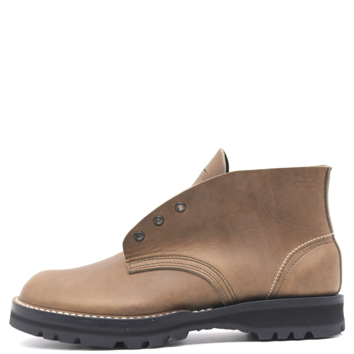 A single brown leather ankle boot with a black lug sole, white contrast stitching, and metal eyelets, shown from a side profile on a white background.