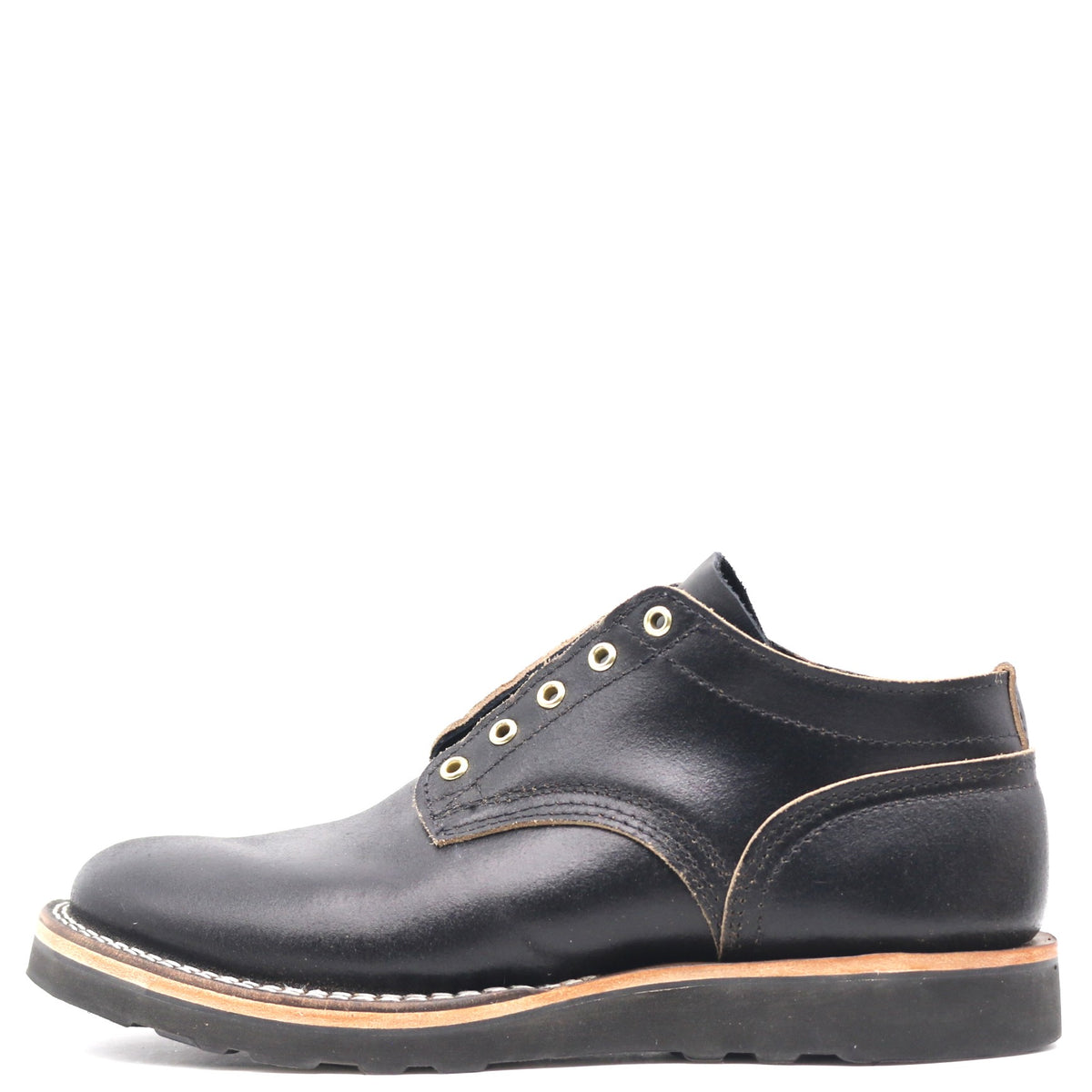 A black leather lace-up ankle boot with gold-tone metal eyelets, a tan welt, and a black sole, shown from a side profile on a white background.