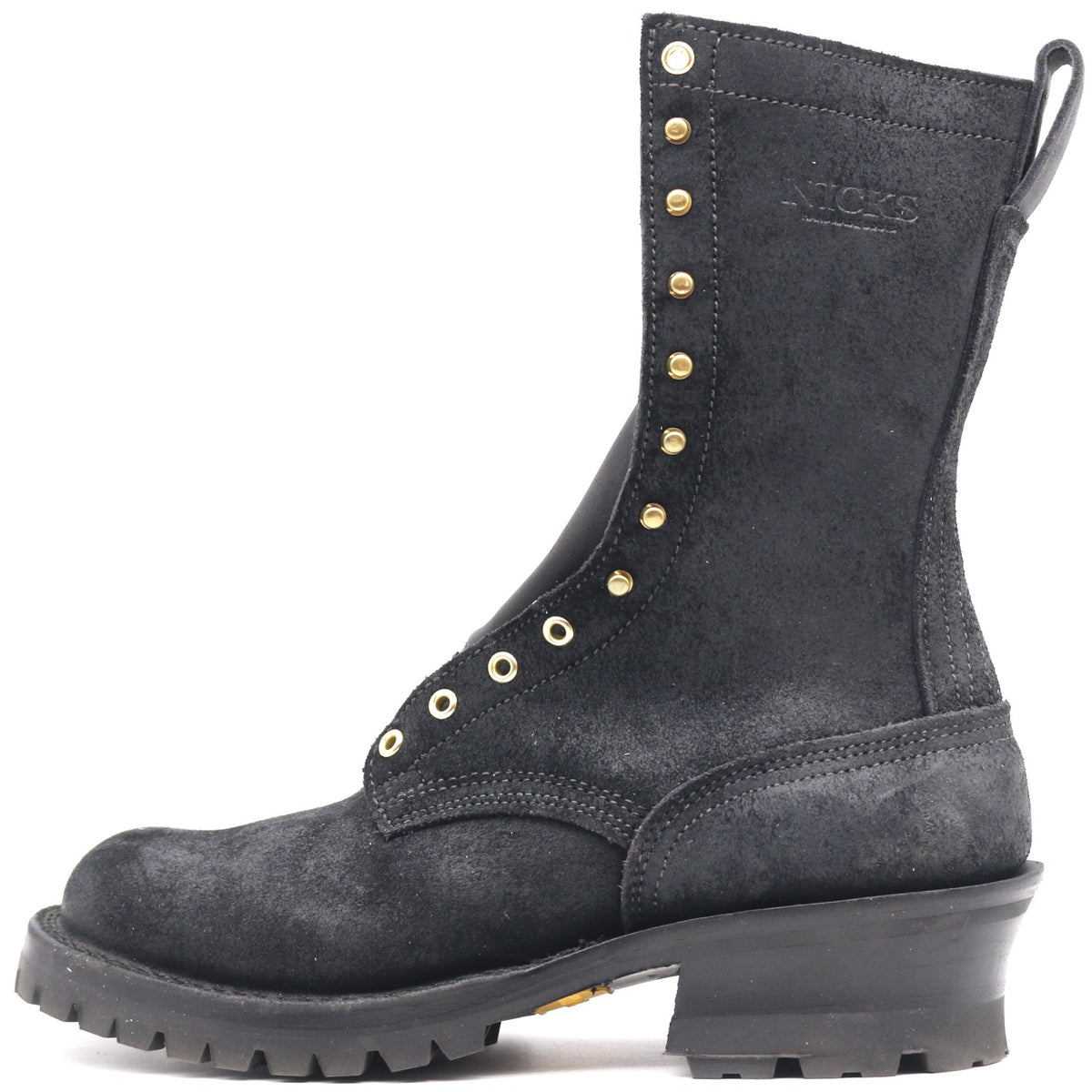 A black suede lace-up work boot with gold-tone metal studs and eyelets, a thick black lug sole, and a stacked heel, shown from a side profile on a white background.