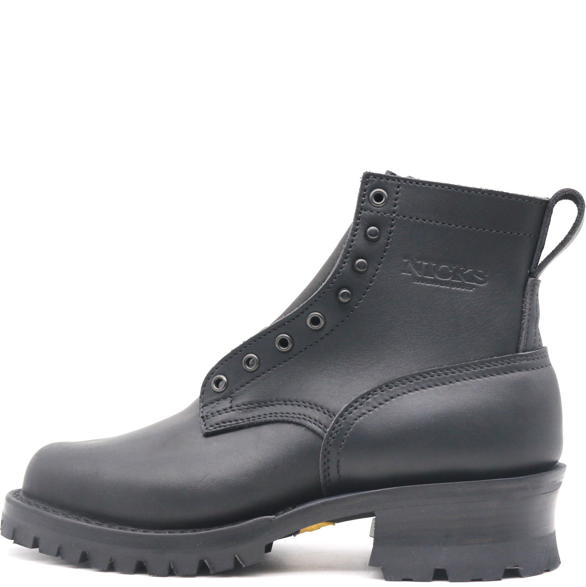 A black leather ankle boot with lace-up front, metal eyelets, a pull tab, and a chunky lug sole, shown from a side profile on a white background. The brand name 'NICKS' is embossed on the side.