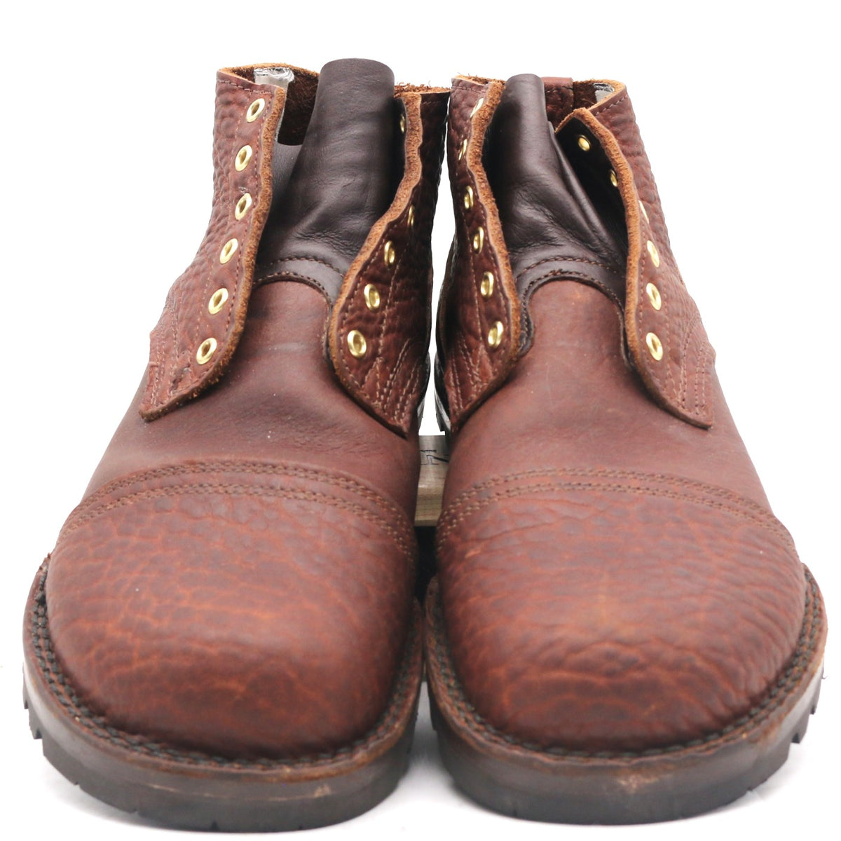 A pair of brown leather lace-up boots with a textured toe cap and gold-tone eyelets, photographed against a plain white background.