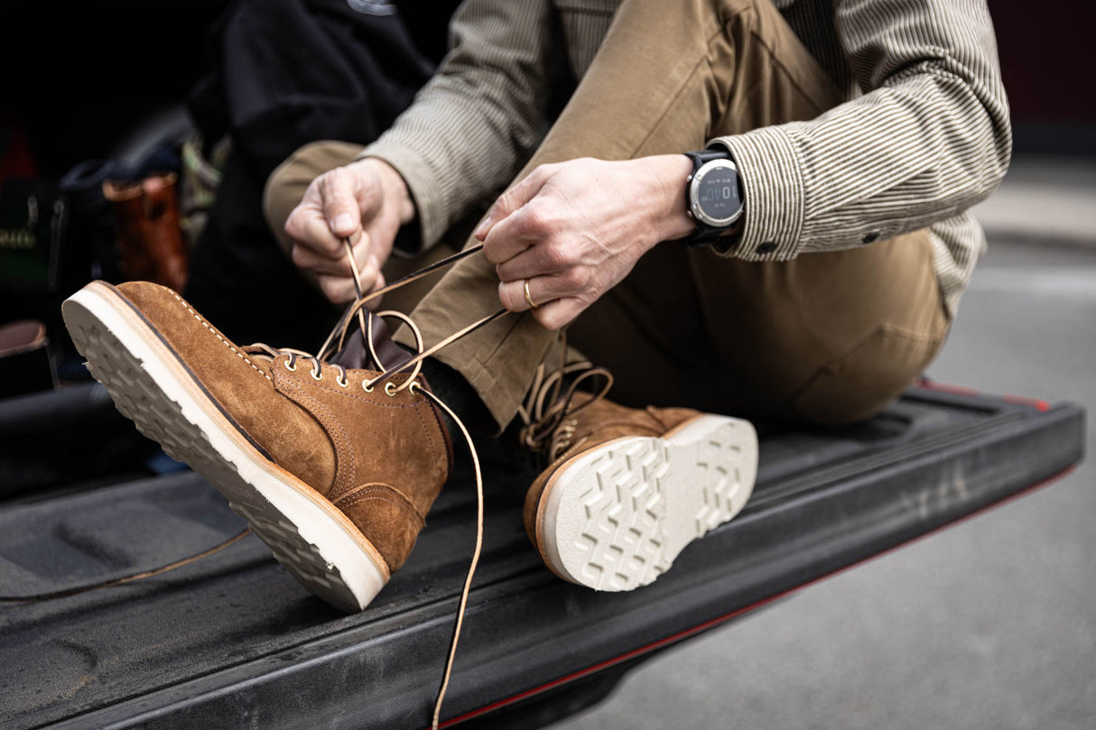 Aldert wedge sole boot in brown being worn for a walk in town