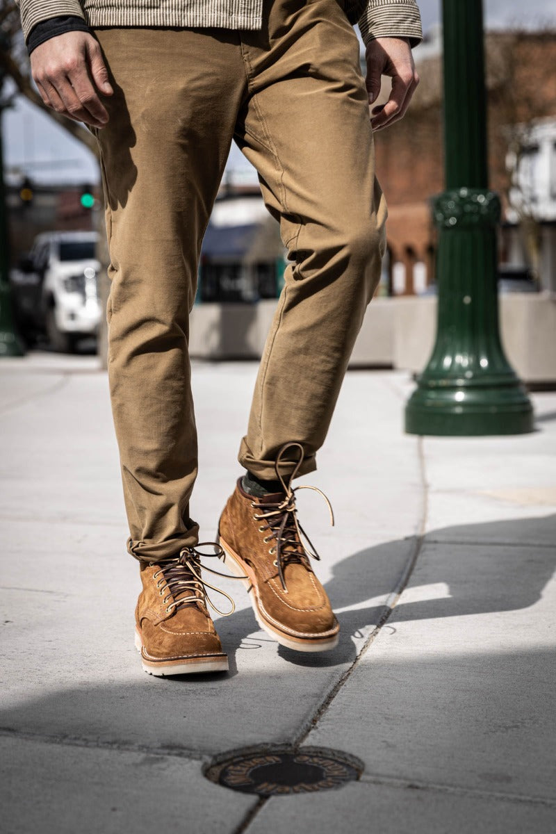 Aldert wedge sole boot in brown being worn for a walk in town