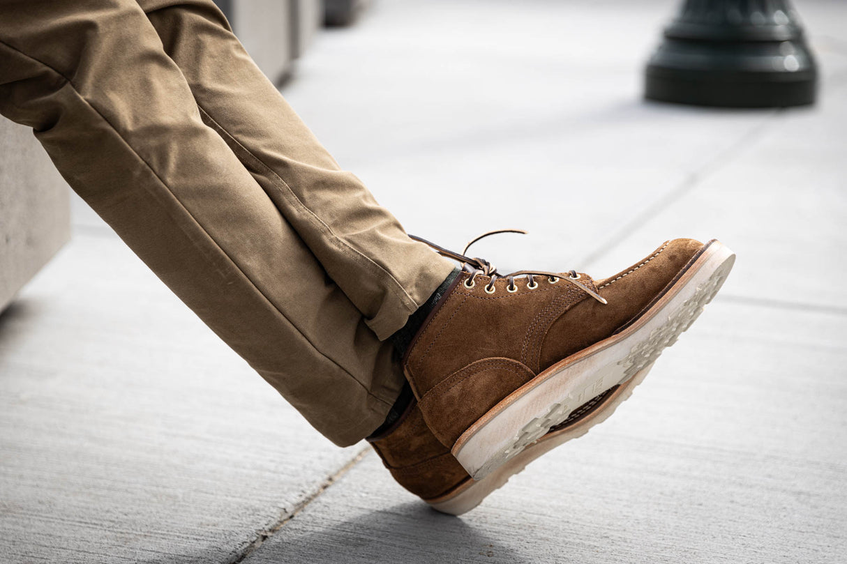 Aldert wedge sole boot in brown being worn for a walk in town