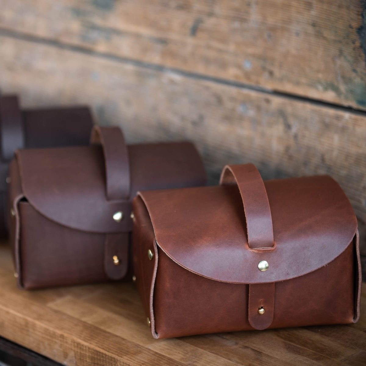 3 Everyday Leather Carry Cases sitting on a table.