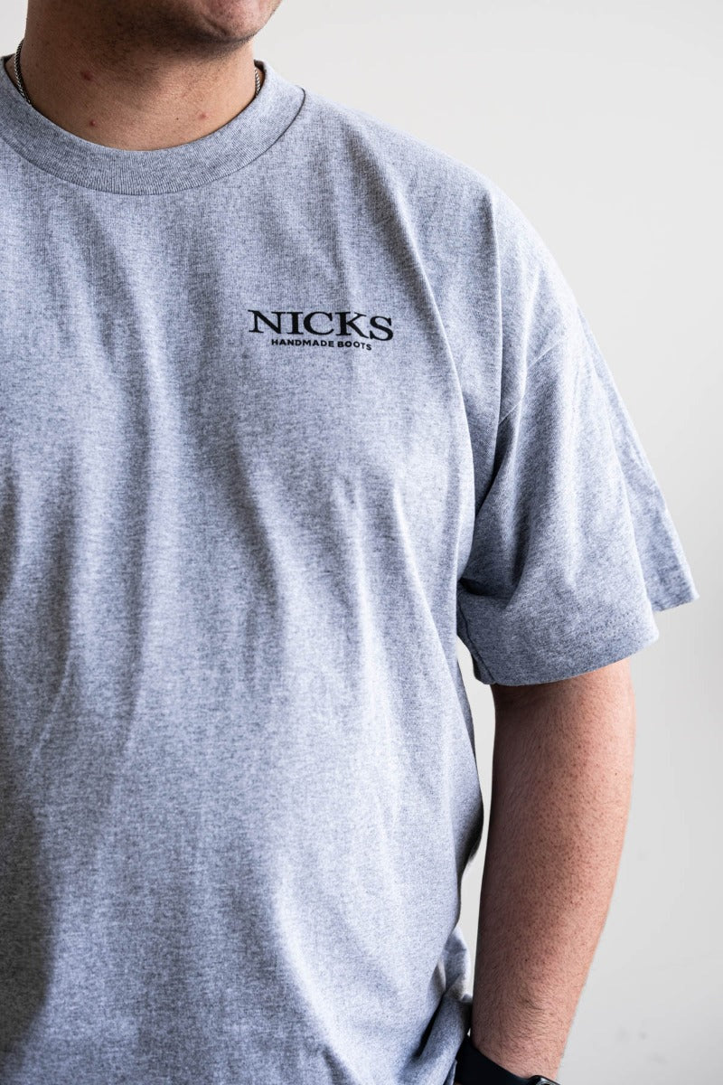 Grey T-shirt with a boot ad on it