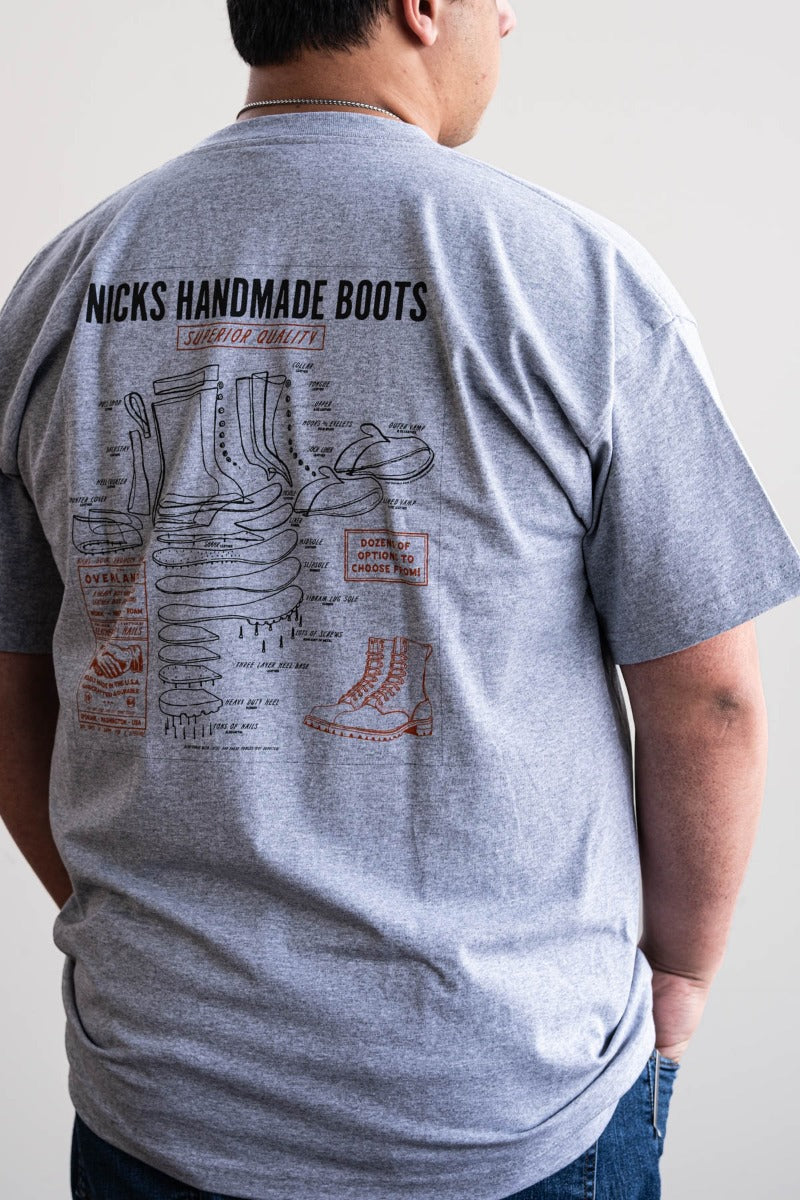 Grey T-shirt with a boot ad on it