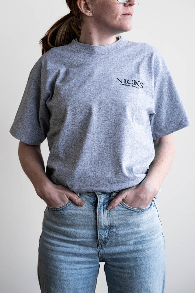 Grey T-shirt with a boot ad on it