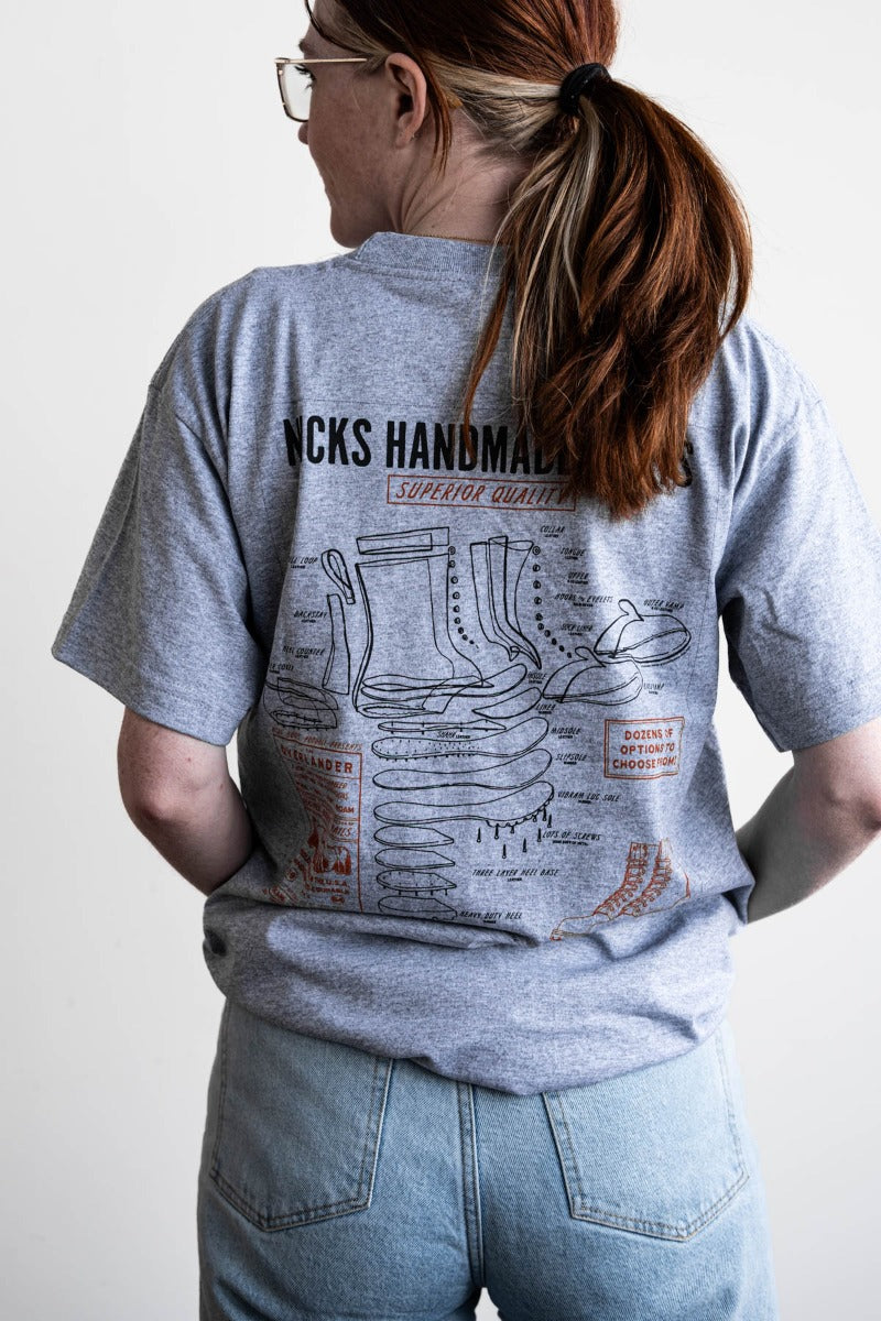 Grey T-shirt with a boot ad on it