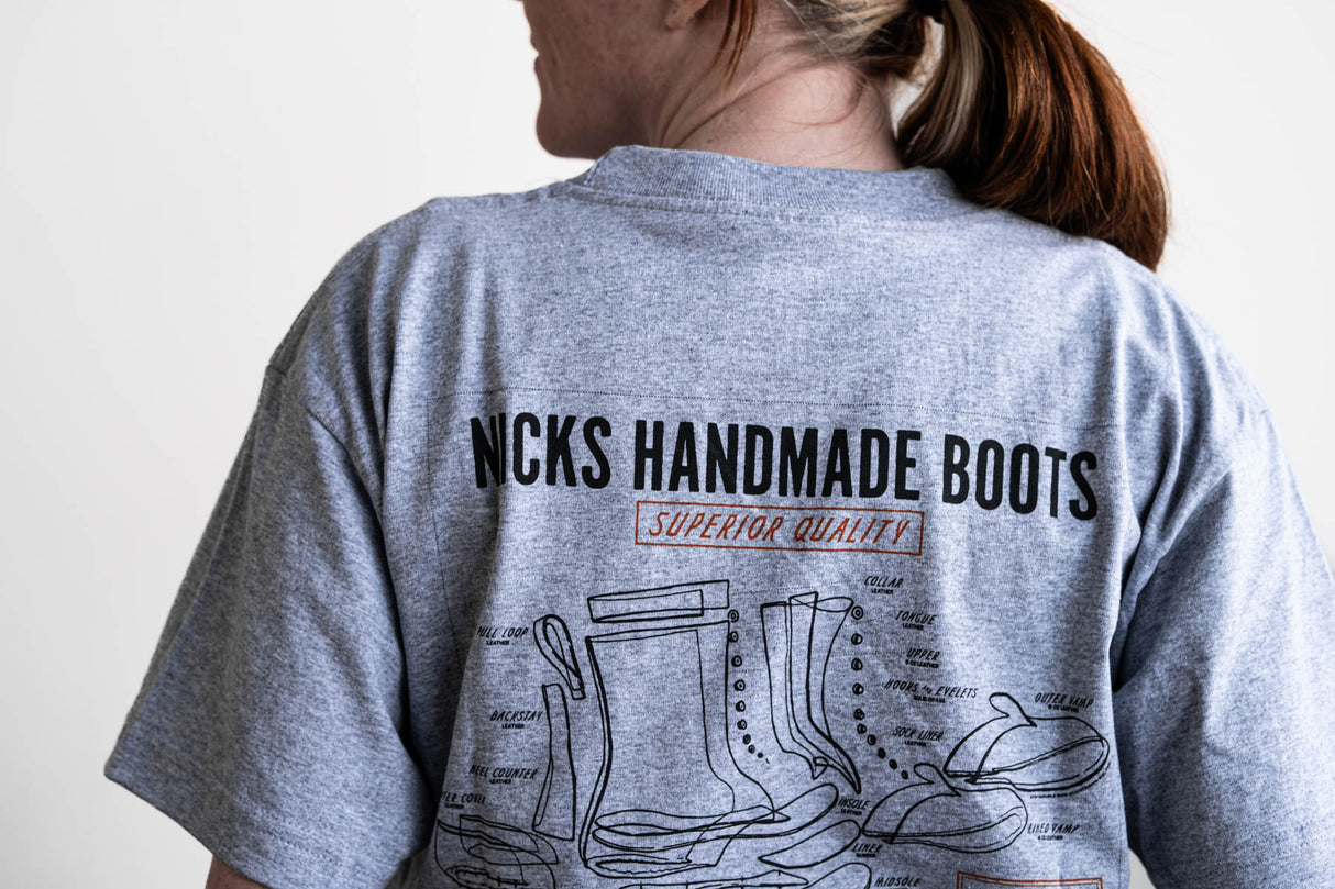 Grey T-shirt with a boot ad on it