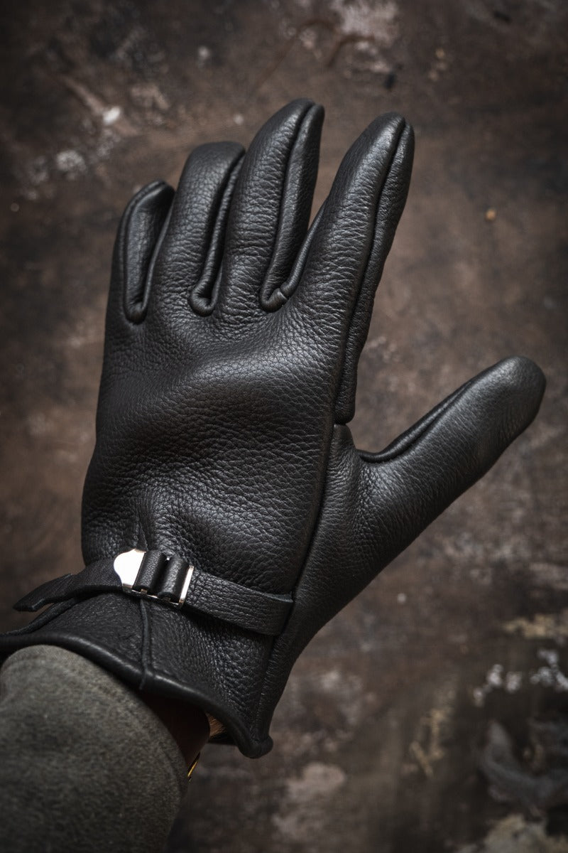 Nicks Fire Gloves in black on hand with adjustable wrist strap