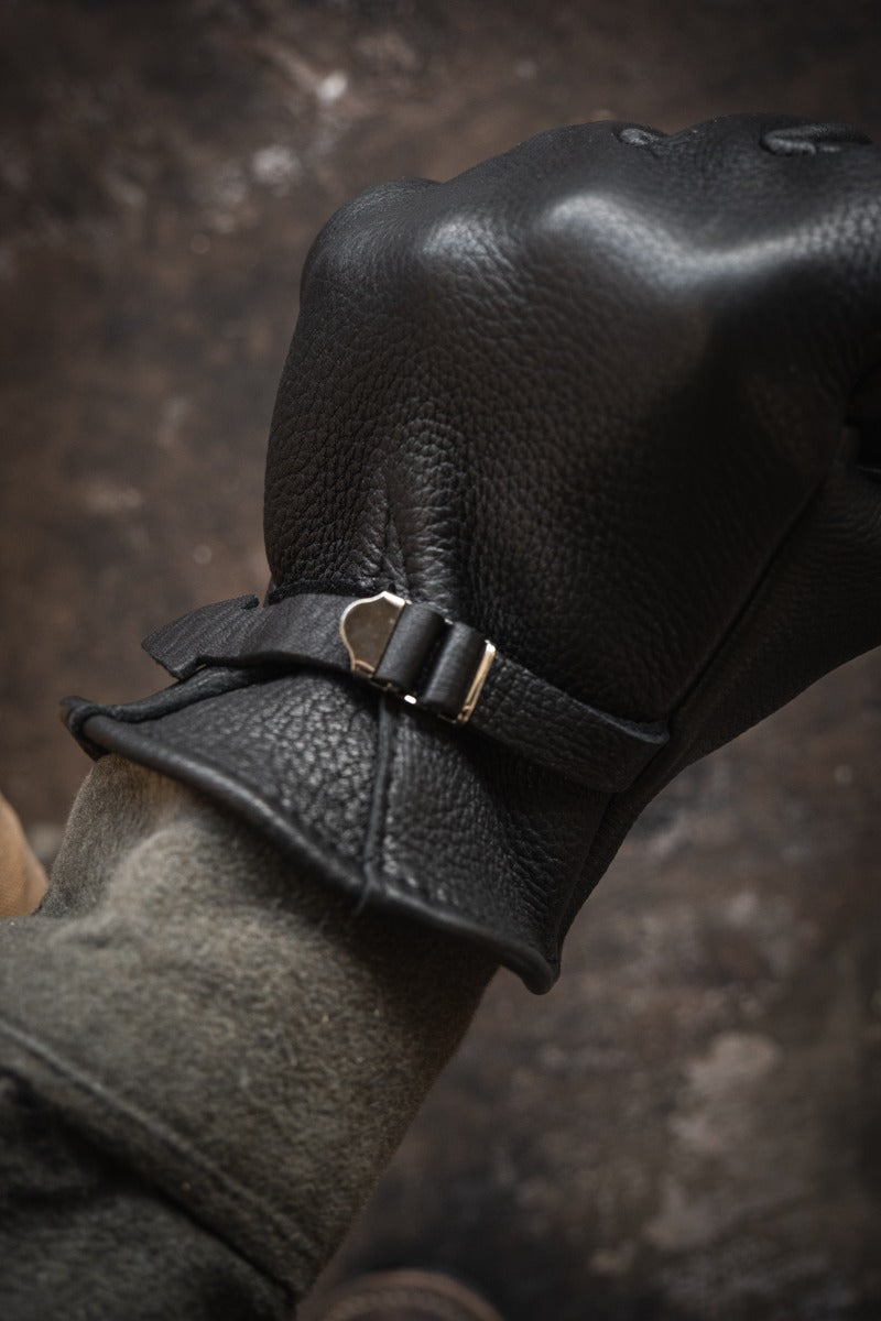 Nicks Fire Gloves in black on hand with adjustable wrist strap