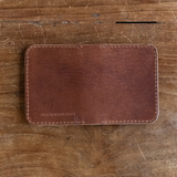 Brown calf leather wallet with rounded corners and perimeter stitching stamped with Nicks Handmade Boots
