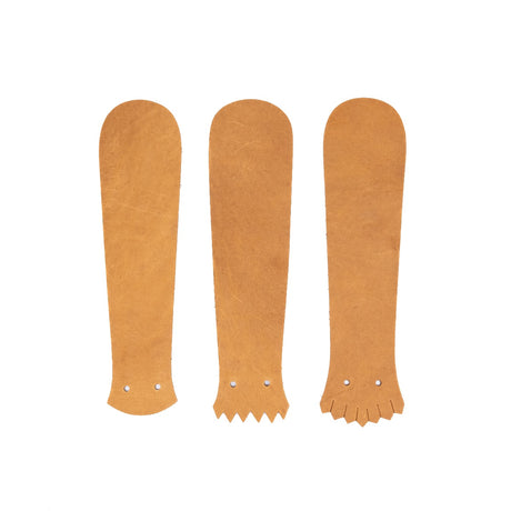 Tan leather Kilties on a white background. 