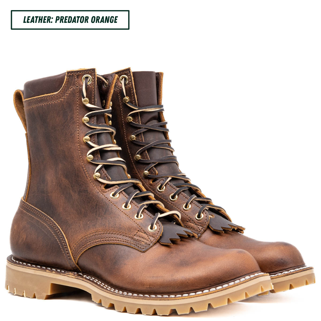 A pair of distressed brown leather lace-up boots with tan laces and metal eyelets, shown on a white background with a text label in the top left that reads 'LEATHER: PREDATOR ORANGE'.