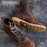 Two rugged lace-up boots in distressed brown leather, one upright and one angled to show the sole, placed on a dark textured surface. A text label in the top left reads 'LEATHER: PREDATOR ORANGE'.