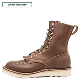 Moctoepro boot, one sitting side profile. Label on top left corner that reads "LEATHER: 1964 BROWN."