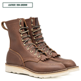 Moctoepro boots, both sitting together facing right side. Label on top left corner that reads "LEATHER: 1964 BROWN."