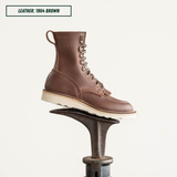 Moctoepro boot, one sitting on boot jack. Label on top left corner that reads "LEATHER: 1964 BROWN."