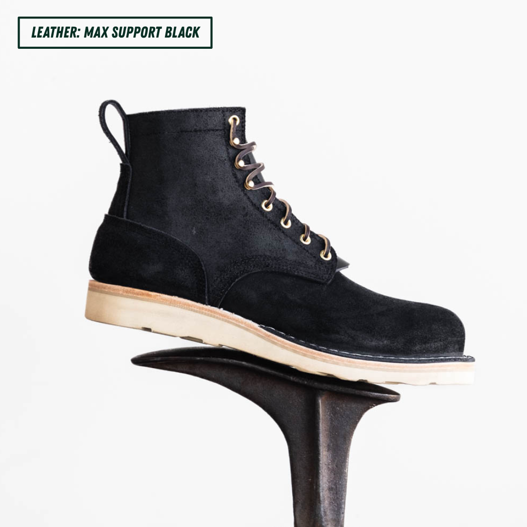Short black boot sitting on boot jack. Top left reads "LEATHER: MAX SUPPORT BLACK."