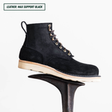 Short black boot sitting on boot jack. Top left reads "LEATHER: MAX SUPPORT BLACK."